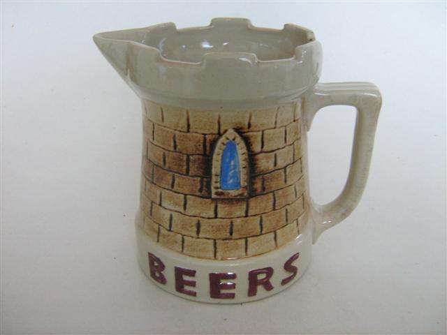CASTLE BEER WATER JUG..15.50cm HIGH X 17.50cm FROM HANDLE TO SPOUT