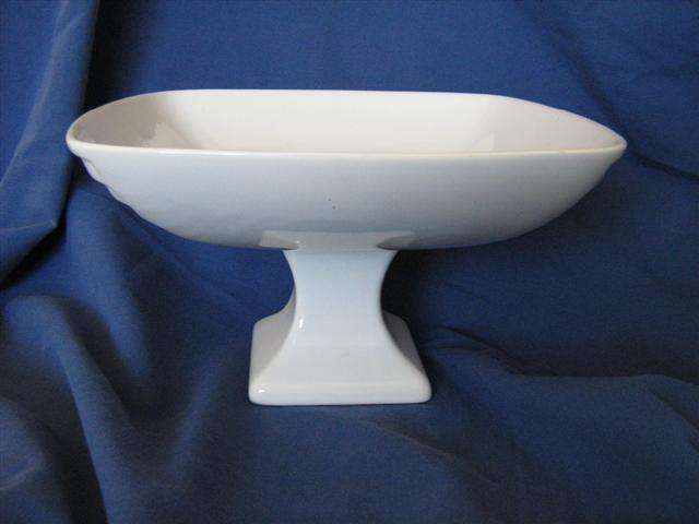 FOOTED  FRUIT BOWL....WHITE. 13.50cm HIGH X 23cm ACROSS.....BASE 9cm ACROSS