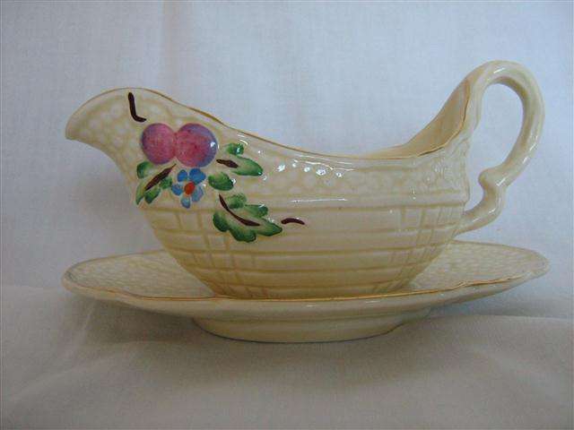CROWN DEVON... CREAM BOAT AND SAUCER...SAUCER 13.70cm x 9.30cm WIDE...JUG. 13.50cm X 7cm HIGH.