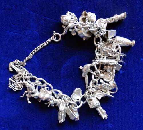 ## Sterling Silver charm Bracelett over 105grams with 30 Charms ##