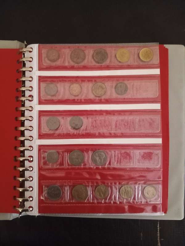 14 Page album filled with over 100 World  coins