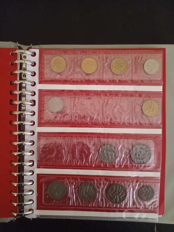 14 Page album filled with over 100 World  coins
