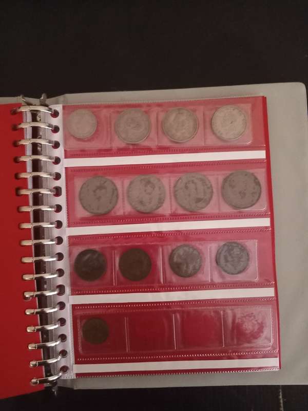 14 Page album filled with over 100 World  coins