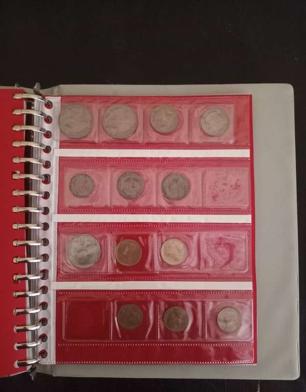14 Page album filled with over 100 World  coins