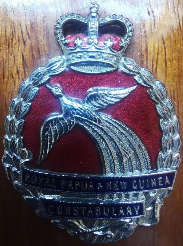 Royal Papua and New Guinea Constabulary enameled hat badge on wooden plaque - rare