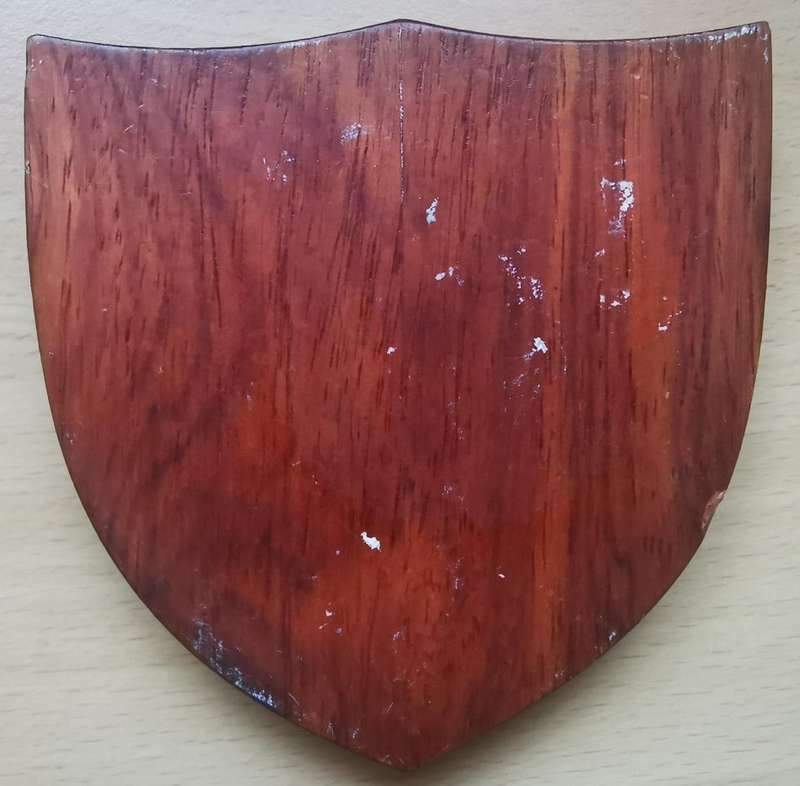 Royal Papua and New Guinea Constabulary enameled hat badge on wooden plaque - rare