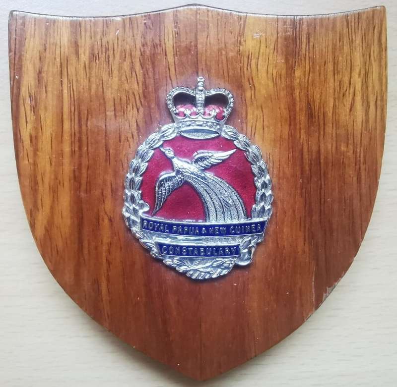 Royal Papua and New Guinea Constabulary enameled hat badge on wooden plaque - rare