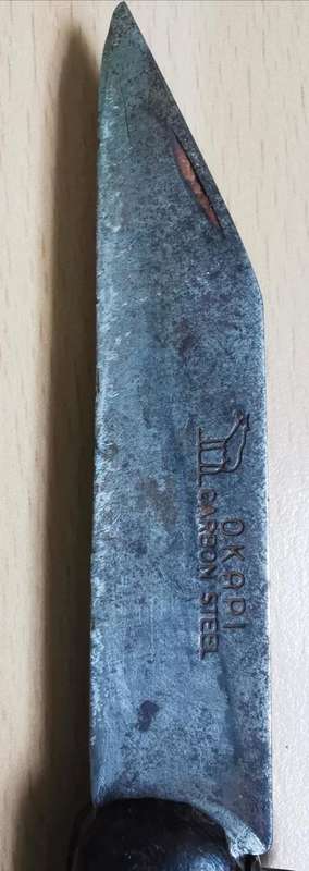 Vintage Okapi folding pocket knife stamped `Carbon Steel`, with moon and stars inlay