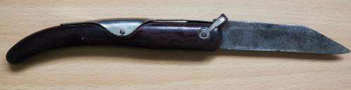 Vintage Okapi folding pocket knife stamped `Carbon Steel`, with moon and stars inlay