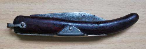 Vintage Okapi folding pocket knife stamped `Carbon Steel`, with moon and stars inlay