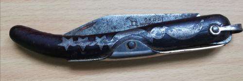 Vintage Okapi folding pocket knife stamped `Carbon Steel`, with moon and stars inlay