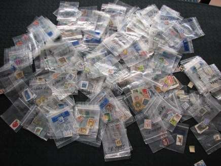 200 x Bank Bags with assorted World Stamps mostly good+ unmounted. Some single stamps, some + more