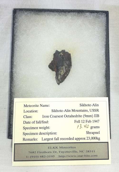 Sikhote-Alin Iron Meteorite Fragment in Presentation Box behind Glass