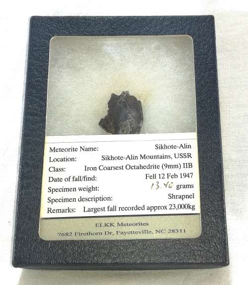 Sikhote-Alin Iron Meteorite Fragment in Presentation Box behind Glass