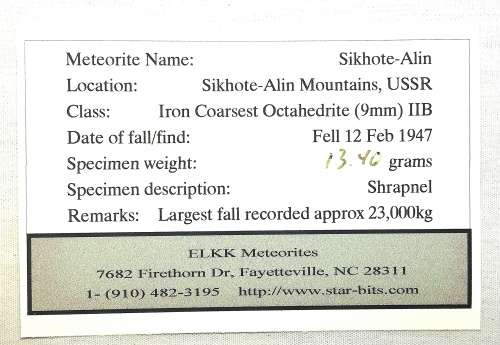 Sikhote-Alin Iron Meteorite Fragment in Presentation Box behind Glass