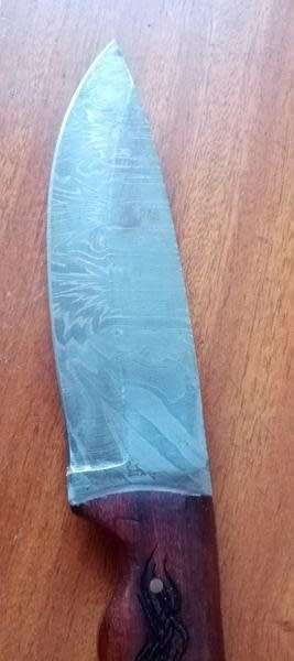 Stunning Damascus steel knife with carved wolf motive handle and leather sheath