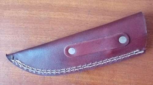 Stunning Damascus steel knife with carved wolf motive handle and leather sheath