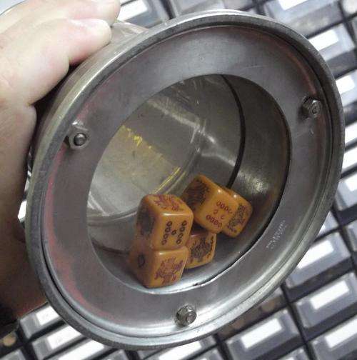 Pewter beer mug with glass bottom containing 5 poker dice