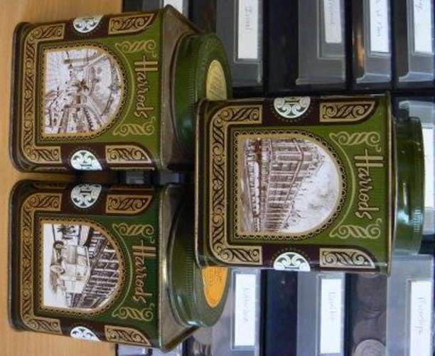 Three green Harrods tea tins