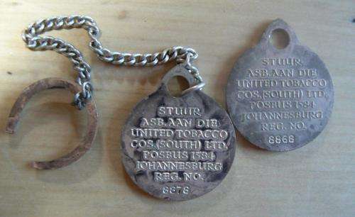 Pair of rare United Tobacco Johannesburg key tokens, numbered - one with chain and horseshoe