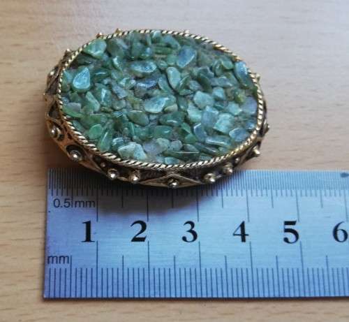 Vintage gold coloured brooch with green semi-precious stones