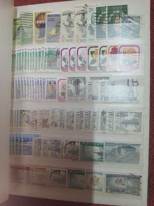 A5 GREEN STOCKBOOK LOADED WITH MIXED WORLD STAMPS 16/32 PAGE