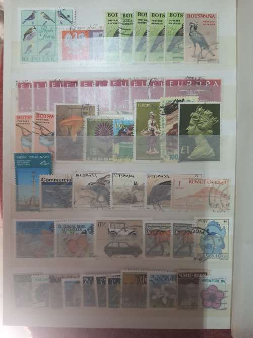 A5 GREEN STOCKBOOK LOADED WITH MIXED WORLD STAMPS 16/32 PAGE
