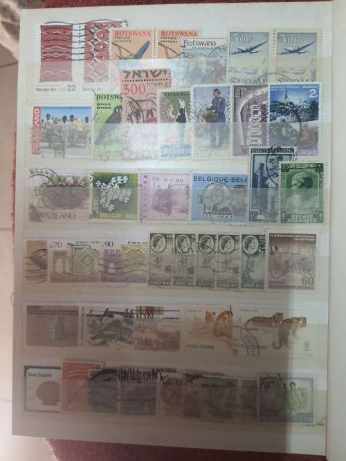 A5 GREEN STOCKBOOK LOADED WITH MIXED WORLD STAMPS 16/32 PAGE