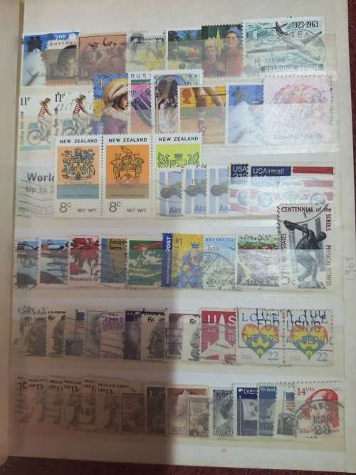 A5 GREEN STOCKBOOK LOADED WITH MIXED WORLD STAMPS 16/32 PAGE