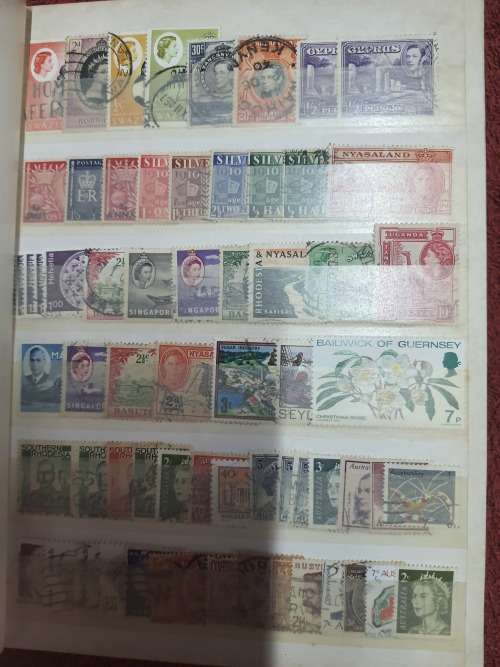A5 GREEN STOCKBOOK LOADED WITH MIXED WORLD STAMPS 16/32 PAGE