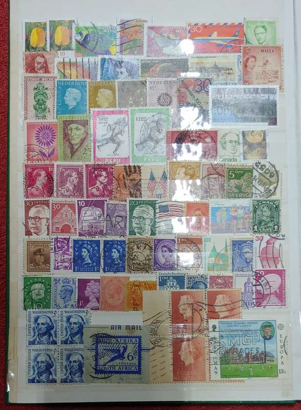 USED GREEN A4 STOCKBOOK FULL OF MIXED WORLD STAMPS 8/16 PAGES