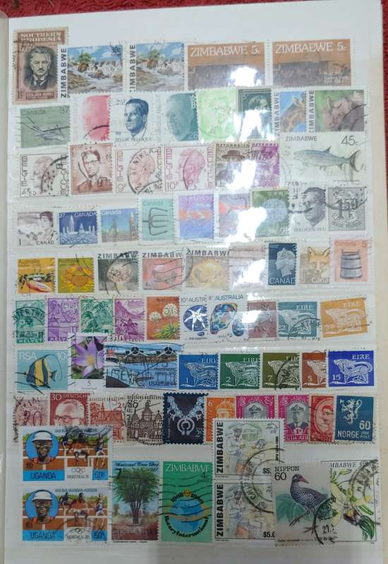 USED GREEN A4 STOCKBOOK FULL OF MIXED WORLD STAMPS 8/16 PAGES