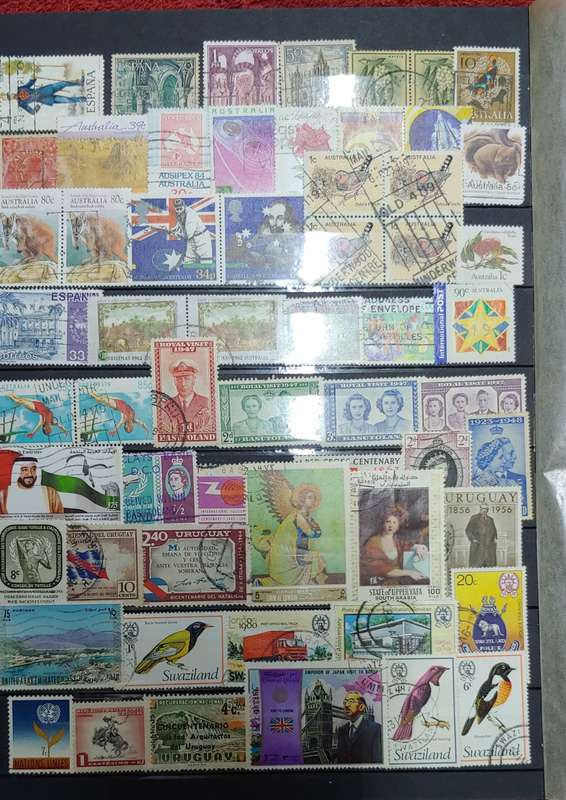 USED MAROON A4 STOCKBOOK WITH BLACK PAGES MIXED WORLD STAMPS 8/16 PAGES