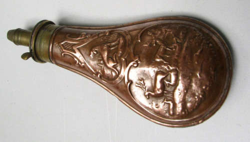 antique brass and copper powder flask for display.