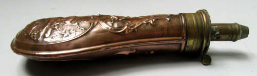 antique brass and copper powder flask for display.