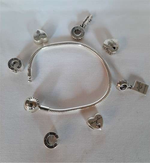 Amazing lot~Authentic Sterling 925 silver Pandora Bracelet with 7 starter charms.