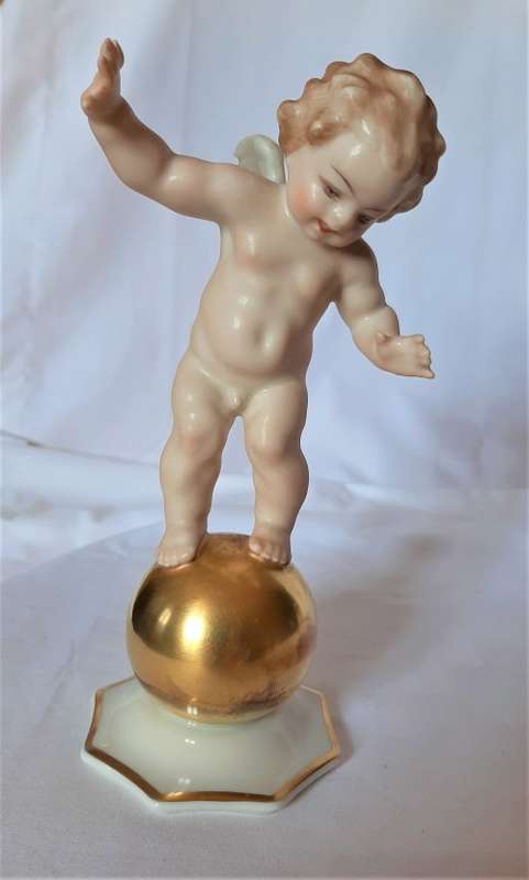 Superb Quality Hutschenreuther Gorgeous fat winged cherub standing on a gold ball, Signed Tutter.