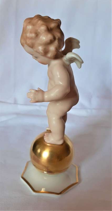 Superb Quality Hutschenreuther Gorgeous fat winged cherub standing on a gold ball, Signed Tutter.