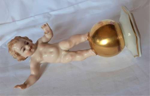 Superb Quality Hutschenreuther Gorgeous fat winged cherub standing on a gold ball, Signed Tutter.