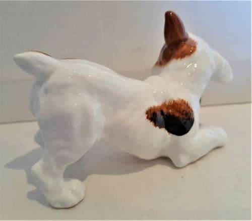 Delightful Royal Doulton puppy playing with a ball in its mouth, practically mint, no damages!