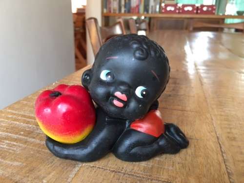 Adorable baby figurine holding an apple
