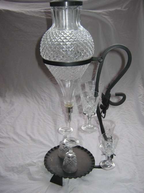GLASS DECANTER ON BLACK METAL STAND & GLASSES