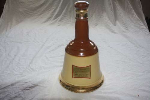 BELLS BLENDED SCOTCH WHISKEY IN WADE BELL SHAPED BOTTLE