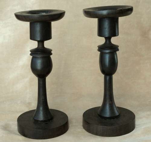 A PAIR OF HAND CARVED WOODEN CANDLE HOLDERS