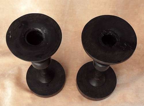 A PAIR OF HAND CARVED WOODEN CANDLE HOLDERS