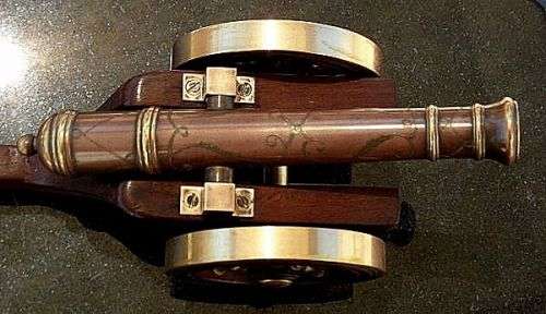 MODEL CANON COPPER AND BRASS,ENGRAVINGS ON GUN BARREL ,WOODEN AND BRASS WHEELS  ETC.