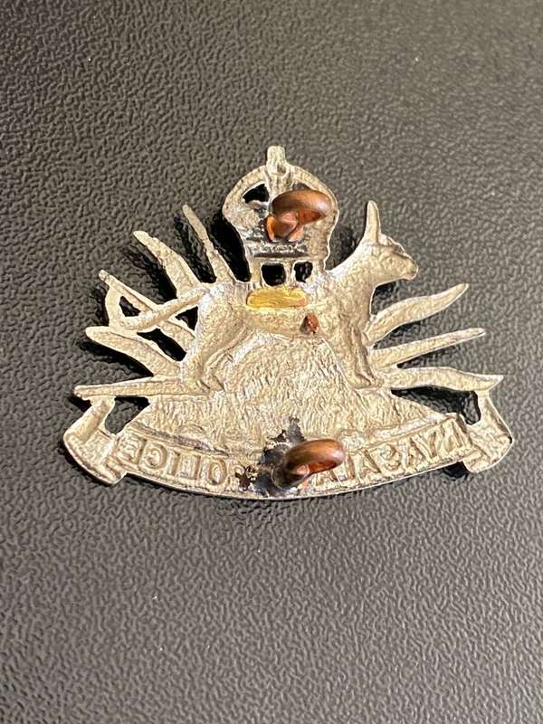 NYASALAND POLICE WHITE METAL K/C CAP BADGE-WORN FROM 1924-MID 1950`S- 2 LUGS