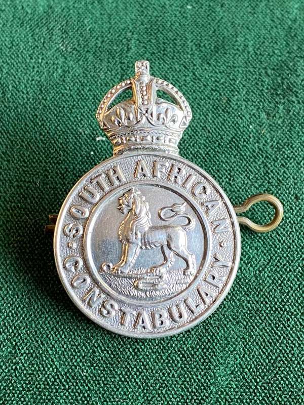 SA CONSTABULARY,WHITE METAL HELMET AND CAP BADGE-SOLID CENTRE-2 LUGS-MEASURES 43X39M
