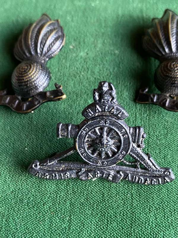 NATAL FIELD ARTILLERY BLACKENED BRONZE CAP BADGE AND COLLAR BADGES(ALSO LATER WORN AS CAP BADGE)APPR