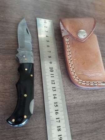 Handmade Damascus steel folding knife with BULL Horn handle scales